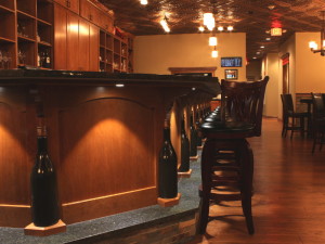 Wine bottle detail along front of custom cabinets