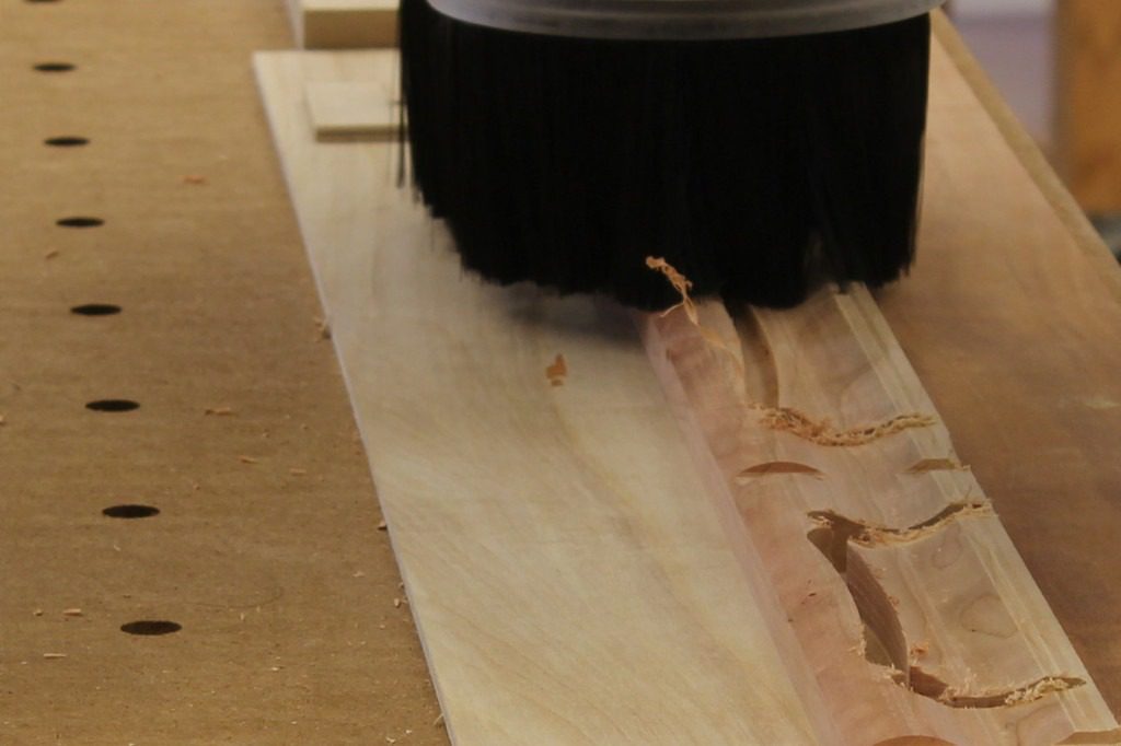 A Machine Tool Camp router cuts some feet for a missal stand