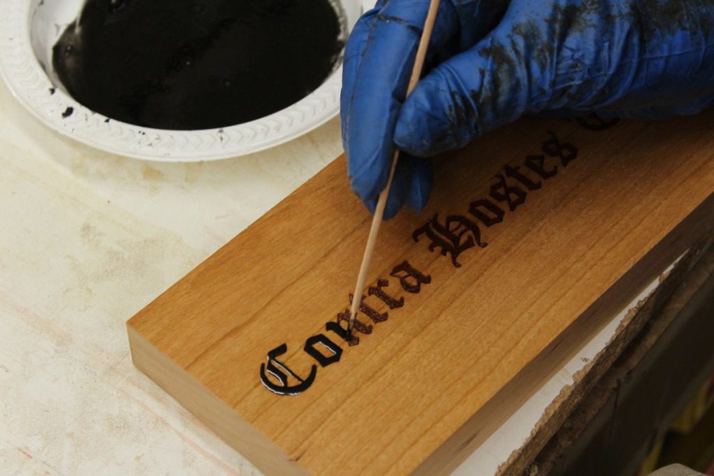 Laser etching being filled with colored resin