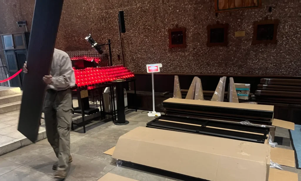 unpacking parts for Holy Cross Chapel pews before assembly